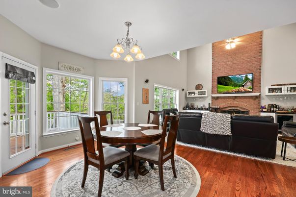 Chandelier, Dining room, Fireplace, Interior, Living room, Stone Walls, Wood Texture Flooring