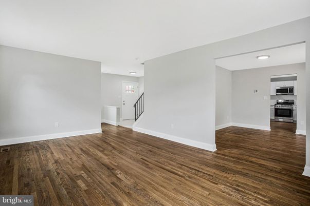 Empty room, Interior, Kitchen, Recessed Lighting, Stainless Steel Appliances, Wood Texture Flooring
