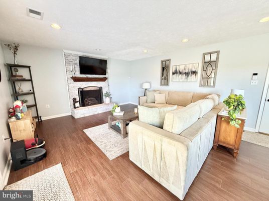 Fireplace, Interior, Living room, Recessed Lighting, Stone Walls, Wood Texture Flooring
