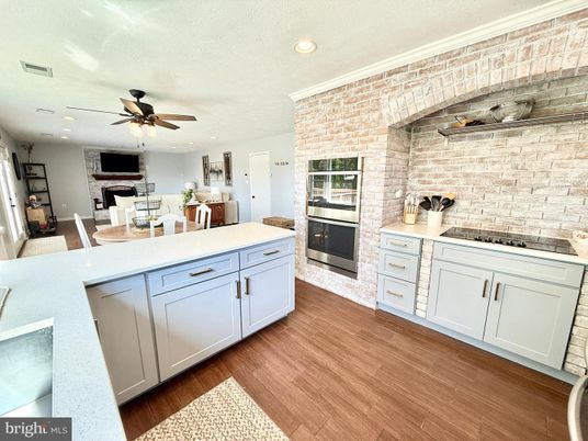 Dining room, Fireplace, Interior, Kitchen, Recessed Lighting, Stone Walls, Wood Texture Flooring