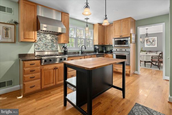 Chandelier, Dining room, Interior, Kitchen, Pendant Lights, Stainless Steel Appliances, Wood Texture Flooring
