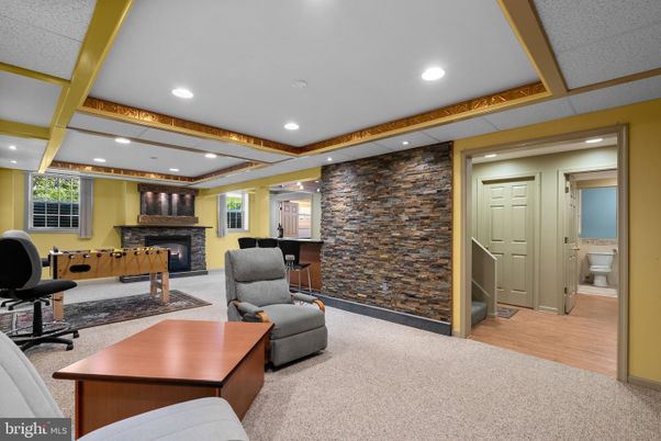 Fireplace, Interior, Living room, Recessed Lighting, Stone Walls, Wood Texture Flooring