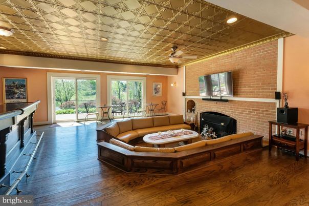 Dining room, Fireplace, Interior, Living room, Recessed Lighting, Stone Walls, Wood Texture Flooring