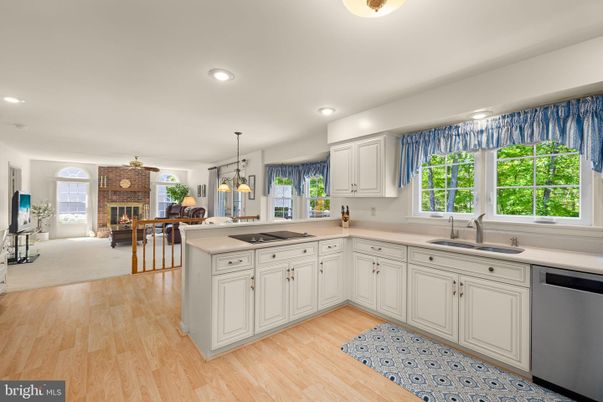 Dining room, Fireplace, Interior, Kitchen, Pendant Lights, Recessed Lighting, Stainless Steel Appliances, Stone Walls, Wood Texture Flooring