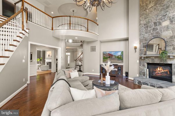 Chandelier, Fireplace, Interior, Living room, Recessed Lighting, Stone Walls, Wood Texture Flooring