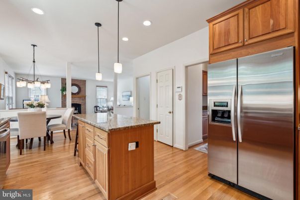 Dining room, Fireplace, Interior, Kitchen, Pendant Lights, Recessed Lighting, Stainless Steel Appliances, Stone Walls, Wood Texture Flooring