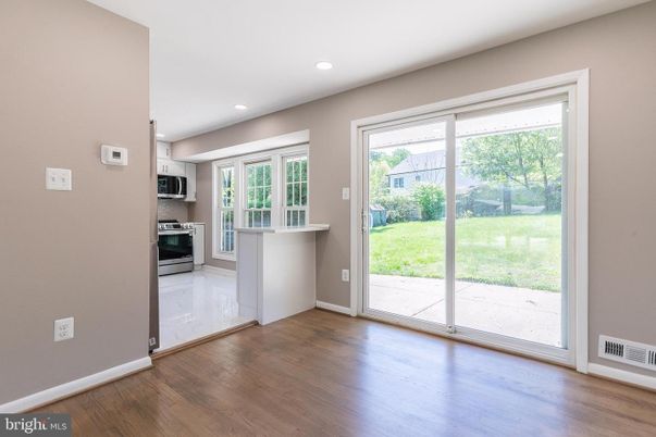 Empty room, Interior, Kitchen, Recessed Lighting, Stainless Steel Appliances, Wood Texture Flooring