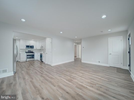 Empty room, Interior, Kitchen, Recessed Lighting, Stainless Steel Appliances, Wood Texture Flooring