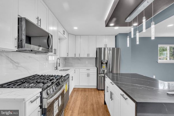 Interior, Kitchen, Marble Walls, Recessed Lighting, Stainless Steel Appliances, Wood Texture Flooring
