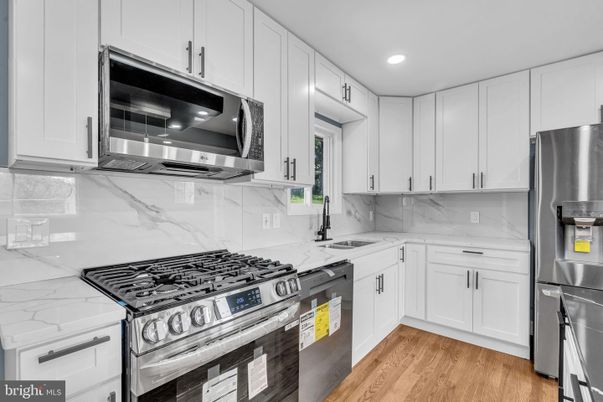 Interior, Kitchen, Marble Walls, Recessed Lighting, Stainless Steel Appliances, Wood Texture Flooring