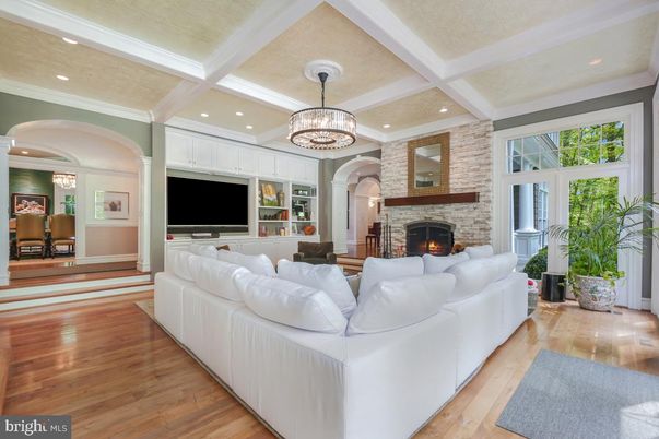 Chandelier, Fireplace, Interior, Living room, Recessed Lighting, Stone Walls, Wood Texture Flooring