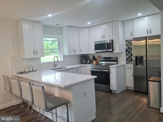 Interior, Kitchen, Marble Walls, Recessed Lighting, Stainless Steel Appliances, Wood Texture Flooring