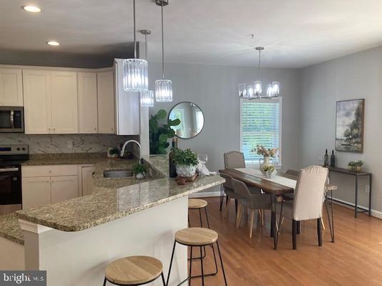 Chandelier, Dining room, Interior, Kitchen, Pendant Lights, Recessed Lighting, Stainless Steel Appliances, Wood Texture Flooring
