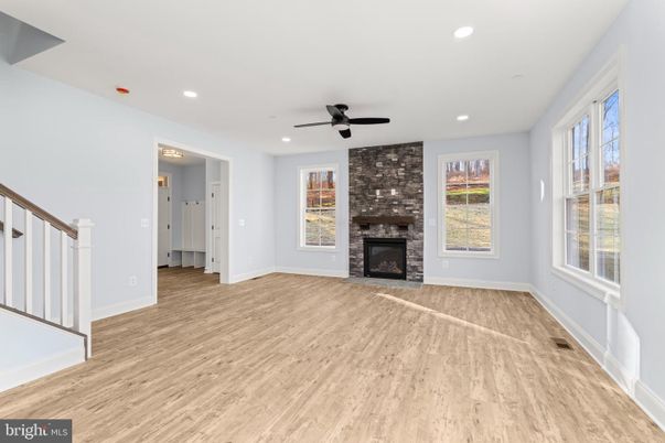 Empty room, Fireplace, Interior, Recessed Lighting, Stone Walls, Wood Texture Flooring