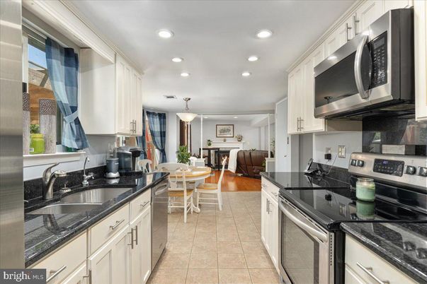 Dining room, Fireplace, Interior, Kitchen, Living room, Pendant Lights, Recessed Lighting, Stainless Steel Appliances, Wood Texture Flooring