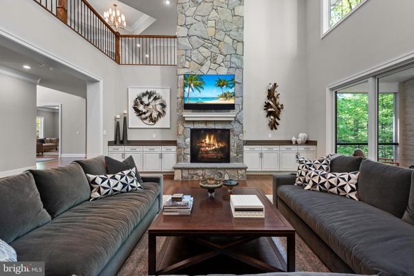 Chandelier, Fireplace, Interior, Living room, Recessed Lighting, Stone Walls, Wood Texture Flooring