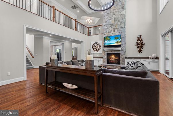 Chandelier, Fireplace, Interior, Living room, Recessed Lighting, Stone Walls, Wood Texture Flooring