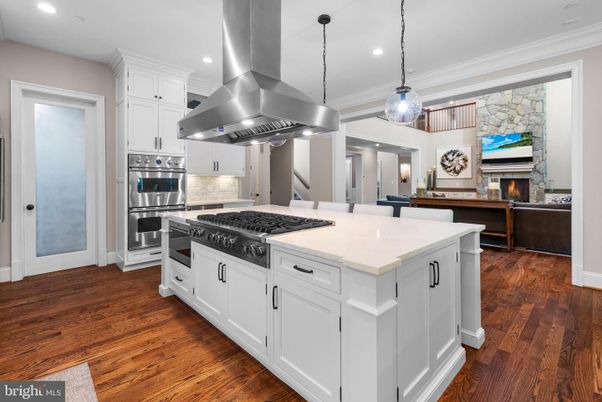 Fireplace, Interior, Kitchen, Pendant Lights, Recessed Lighting, Stainless Steel Appliances, Stone Walls, Wood Texture Flooring