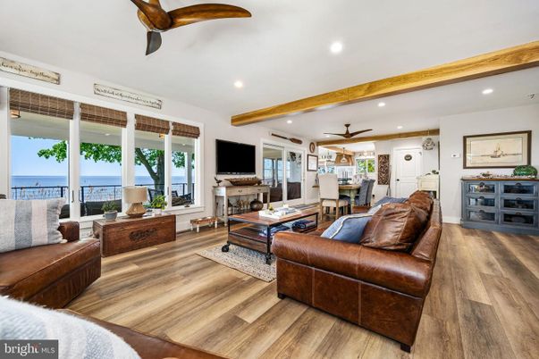 Dining room, Fireplace, Interior, Living room, Recessed Lighting, Water, Wooden Beams, Wood Texture Flooring