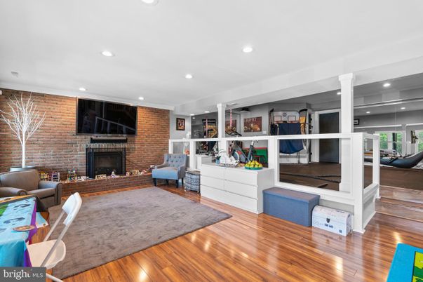 Fireplace, Interior, Living room, Recessed Lighting, Stone Walls, Wood Texture Flooring