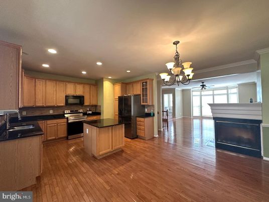 Chandelier, Fireplace, Interior, Kitchen, Recessed Lighting, Stainless Steel Appliances, Wood Texture Flooring