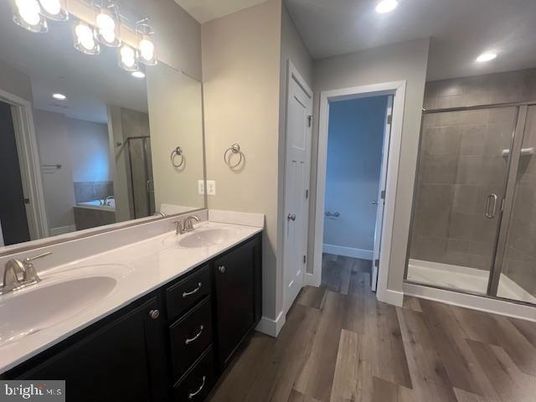 Bathroom, Dual Sink Vanities, Glass Shower, Interior, Recessed Lighting, Wood Texture Flooring