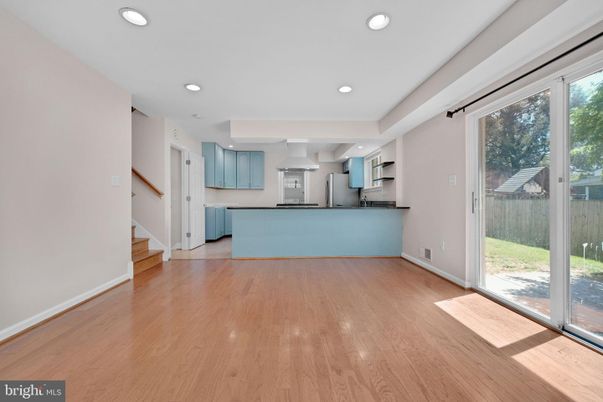 Empty room, Interior, Kitchen, Recessed Lighting, Stainless Steel Appliances, Wood Texture Flooring