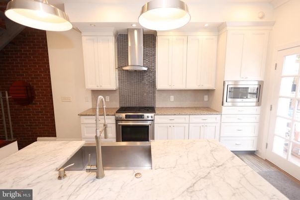 Interior, Kitchen, Pendant Lights, Recessed Lighting, Stainless Steel Appliances, Stone Walls, Wood Texture Flooring