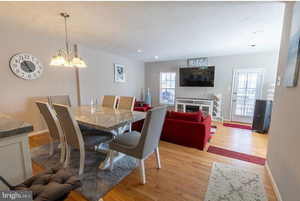Chandelier, Dining room, Fireplace, Interior, Living room, Pendant Lights, Recessed Lighting, Wood Texture Flooring