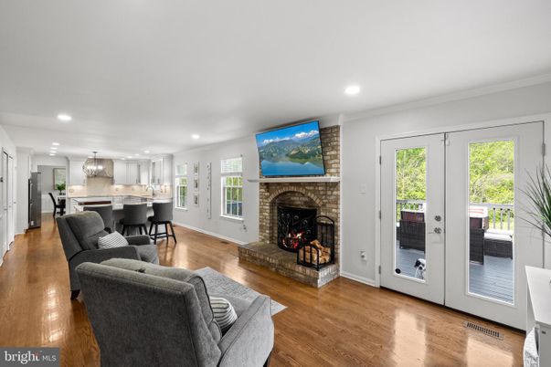 Chandelier, Fireplace, Interior, Kitchen, Living room, Recessed Lighting, Stainless Steel Appliances, Wood Texture Flooring
