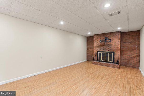 Empty room, Fireplace, Interior, Recessed Lighting, Stone Walls, Wood Texture Flooring