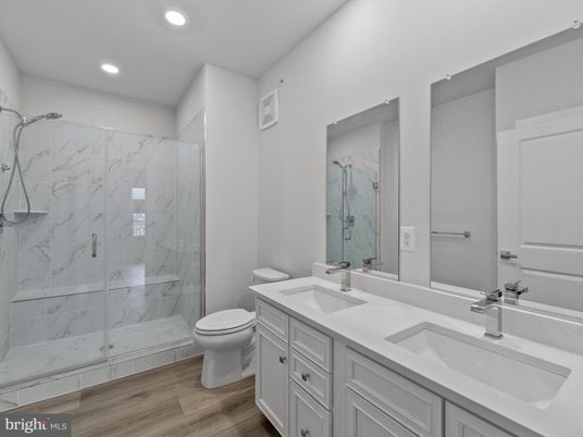 Bathroom, Dual Sink Vanities, Glass Shower, Interior, Marble Walls, Recessed Lighting, Wood Texture Flooring