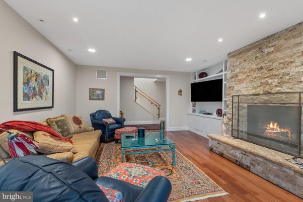 Fireplace, Interior, Living room, Recessed Lighting, Stone Walls, Wood Texture Flooring