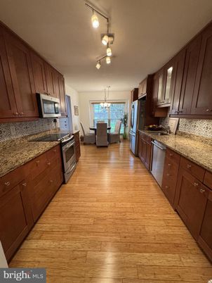 Chandelier, Dining room, Interior, Kitchen, Stainless Steel Appliances, Wood Texture Flooring