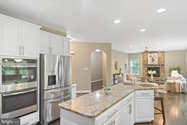 Fireplace, Interior, Kitchen, Living room, Recessed Lighting, Stainless Steel Appliances, Stone Walls, Wood Texture Flooring