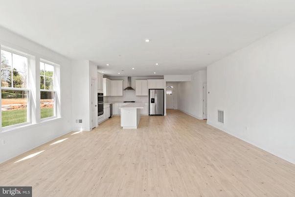 Empty room, Interior, Kitchen, Recessed Lighting, Stainless Steel Appliances, Wood Texture Flooring