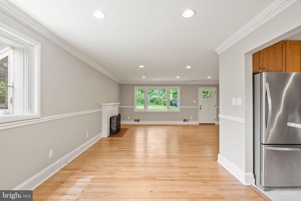 Empty room, Fireplace, Interior, Kitchen, Recessed Lighting, Stainless Steel Appliances, Wood Texture Flooring