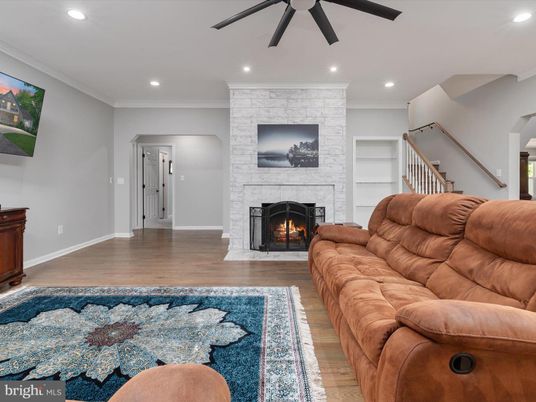 Fireplace, Interior, Living room, Recessed Lighting, Stone Walls, Wood Texture Flooring