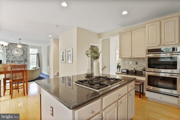 Chandelier, Dining room, Interior, Kitchen, Pendant Lights, Recessed Lighting, Stainless Steel Appliances, Stone Walls, Wood Texture Flooring