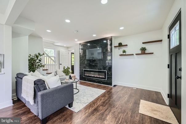 Fireplace, Interior, Living room, Marble Walls, Recessed Lighting, Wood Texture Flooring