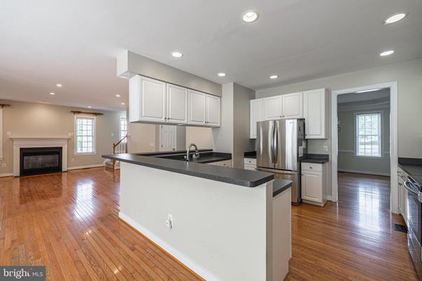 Fireplace, Interior, Kitchen, Recessed Lighting, Stainless Steel Appliances, Wood Texture Flooring