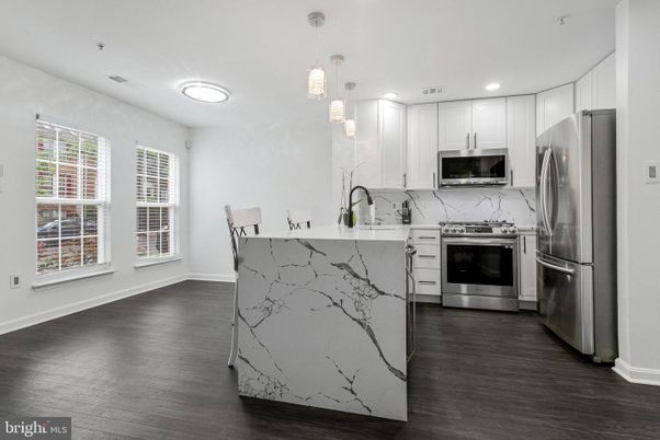 Interior, Kitchen, Marble Walls, Pendant Lights, Recessed Lighting, Stainless Steel Appliances, Wood Texture Flooring