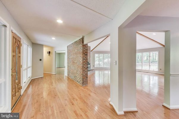 Empty room, Fireplace, Interior, Recessed Lighting, Stone Walls, Wood Texture Flooring
