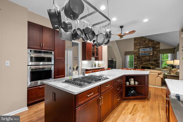 Fireplace, Interior, Kitchen, Living room, Recessed Lighting, Stainless Steel Appliances, Stone Walls, Wood Texture Flooring