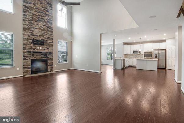 Fireplace, Interior, Kitchen, Pendant Lights, Recessed Lighting, Stainless Steel Appliances, Stone Walls, Wood Texture Flooring