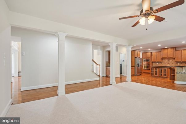 Empty room, Interior, Kitchen, Recessed Lighting, Stainless Steel Appliances, Wood Texture Flooring