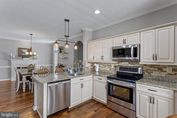 Dining room, Fireplace, Interior, Kitchen, Pendant Lights, Recessed Lighting, Stainless Steel Appliances, Wood Texture Flooring