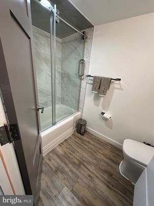 Bathroom, Glass Shower, Interior, Marble Walls, Wood Texture Flooring