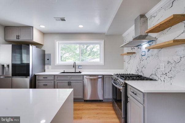 Interior, Kitchen, Marble Walls, Recessed Lighting, Stainless Steel Appliances, Wood Texture Flooring