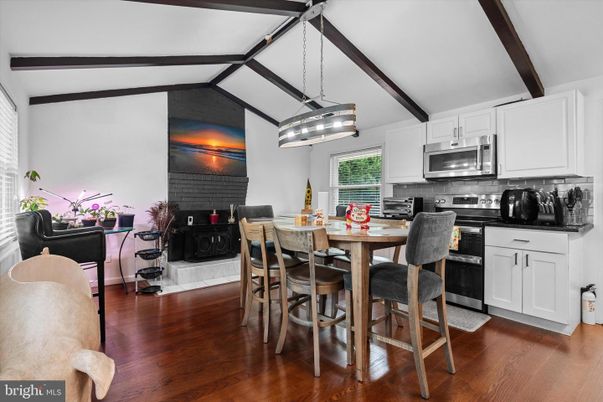 Dining room, Fireplace, Interior, Kitchen, Pendant Lights, Stainless Steel Appliances, Stone Walls, Wooden Beams, Wood Texture Flooring